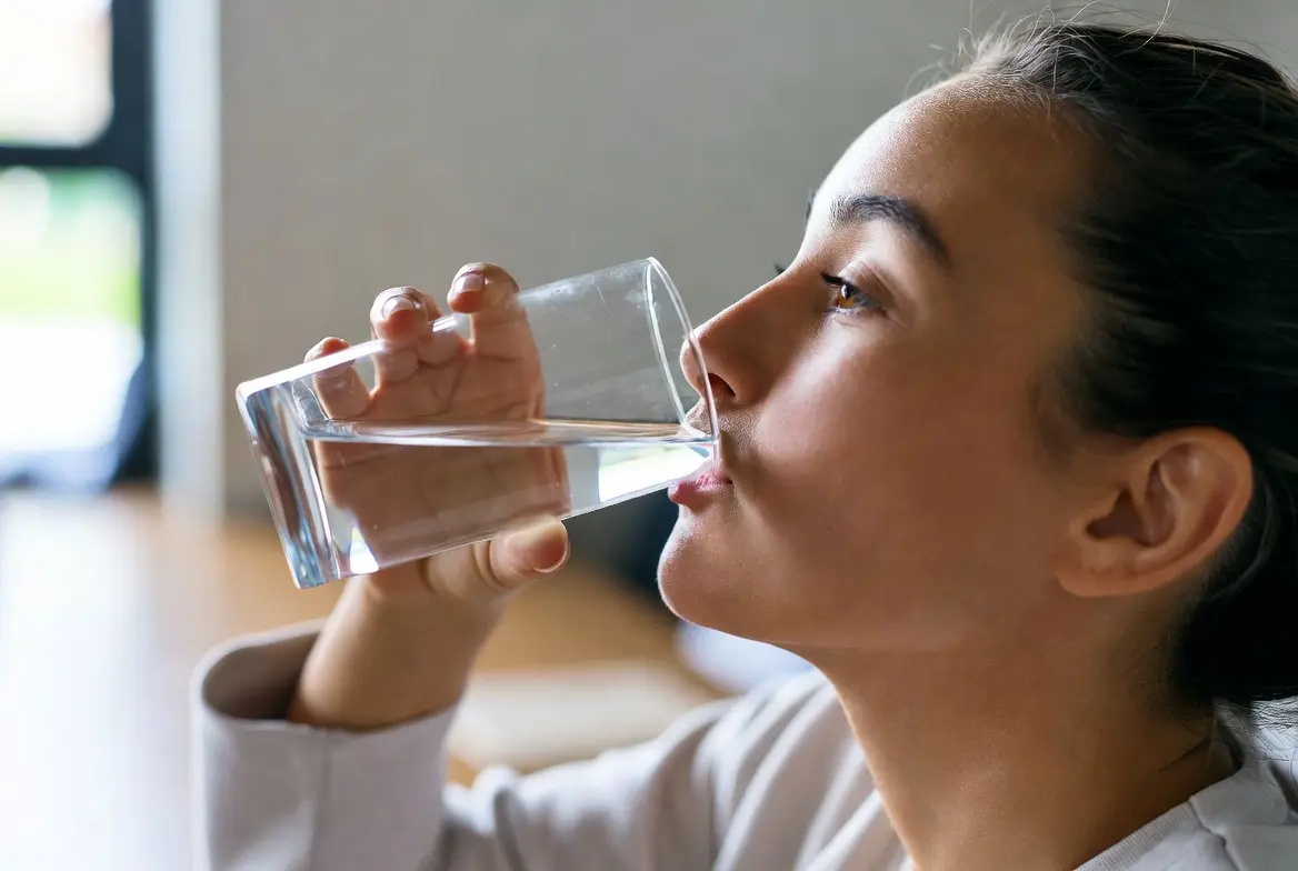 A person drinking water for lithium side effects 
